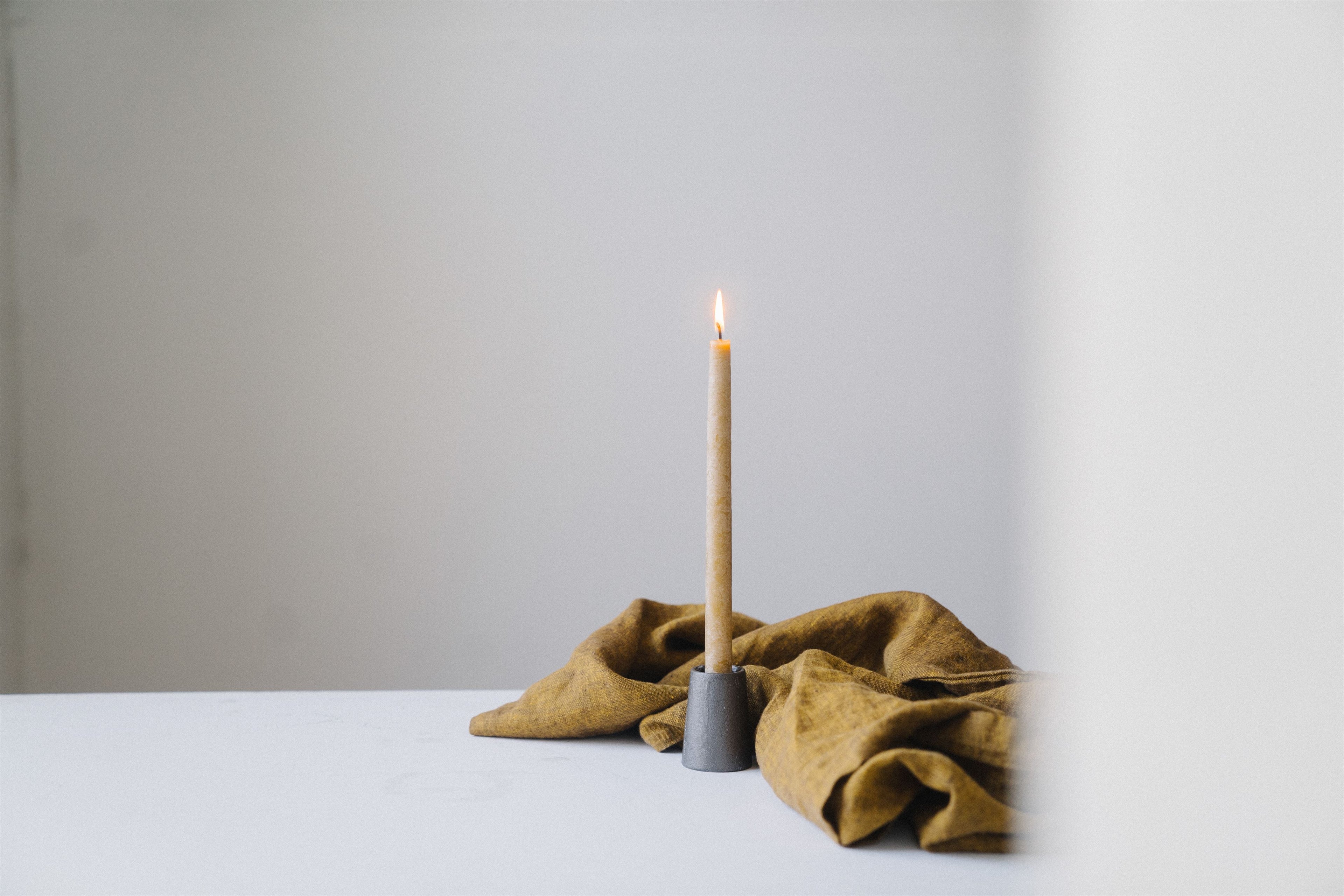 daughters of promise ministry candle and yellow cloth on the table